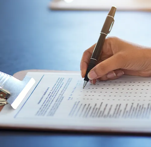 Woman writing on clipboard